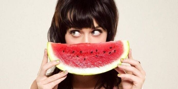 Girl on a watermelon on a watermelon diet