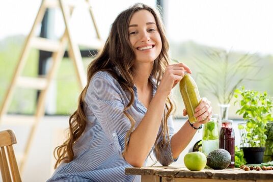 The girl drinks green smoothie for weight loss